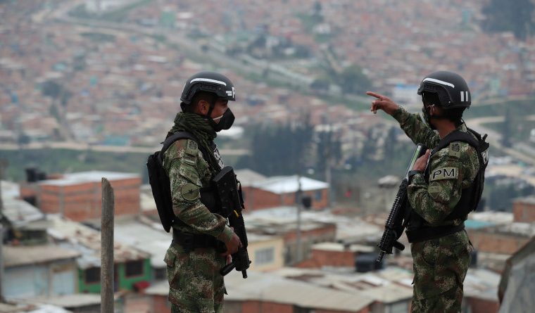 Soldiers patrol on the outskirts of Bogota, Colombia, Monday, March 30, 2020 amid a lockdown to help contain the spread of the new coronavirus. (AP Photo/Fernando Vergara)